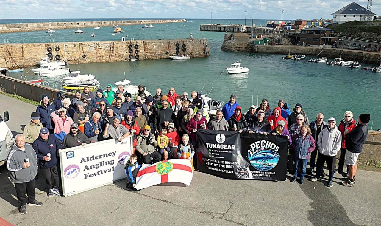 Anglers gathered on the quay at Braye with the festival banner